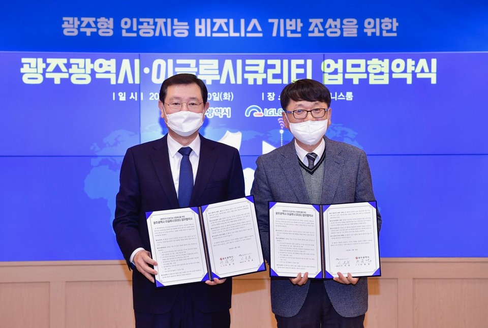 이득춘 이글루시큐리티 대표와(오른쪽) 이용섭 광주광역시장이 광주광역시청에서 광주형 인공지능(AI) 비즈니스 기반 조성을 위한 업무협약서를 교환하고 기념촬영을 하고 있다. (사진=이글루시큐리티)