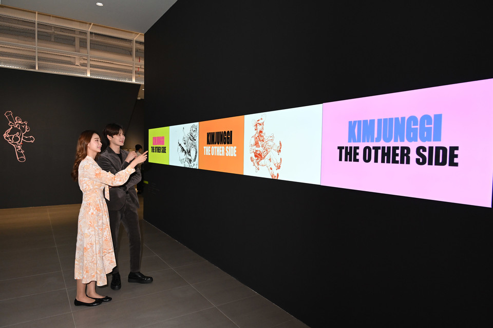 모델들이 LG 디지털 사이니지를 이어붙여 만든 가로 6미터 길이 비디오월을 통해 작품을 감상하고 있다. (제공=LG전자)